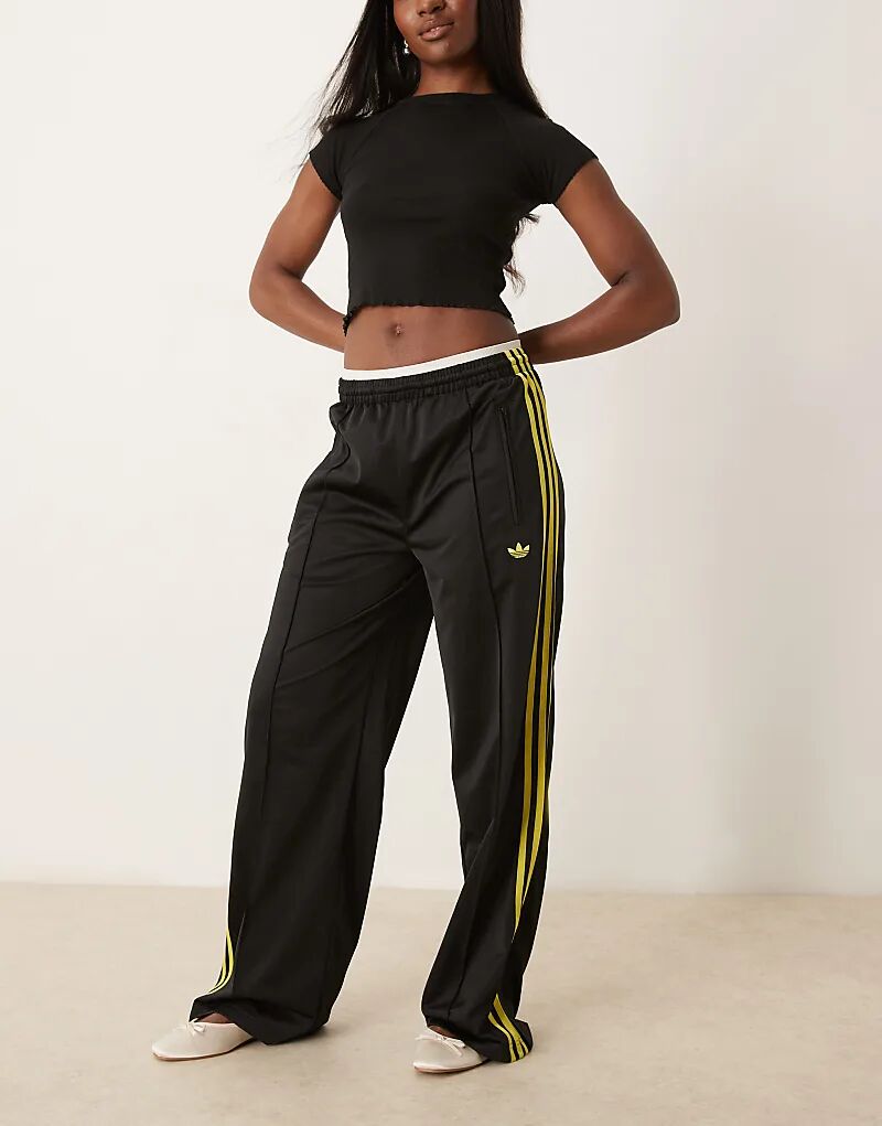 

Спортивные брюки adidas Originals Firebird Loose черного и желтого цветов