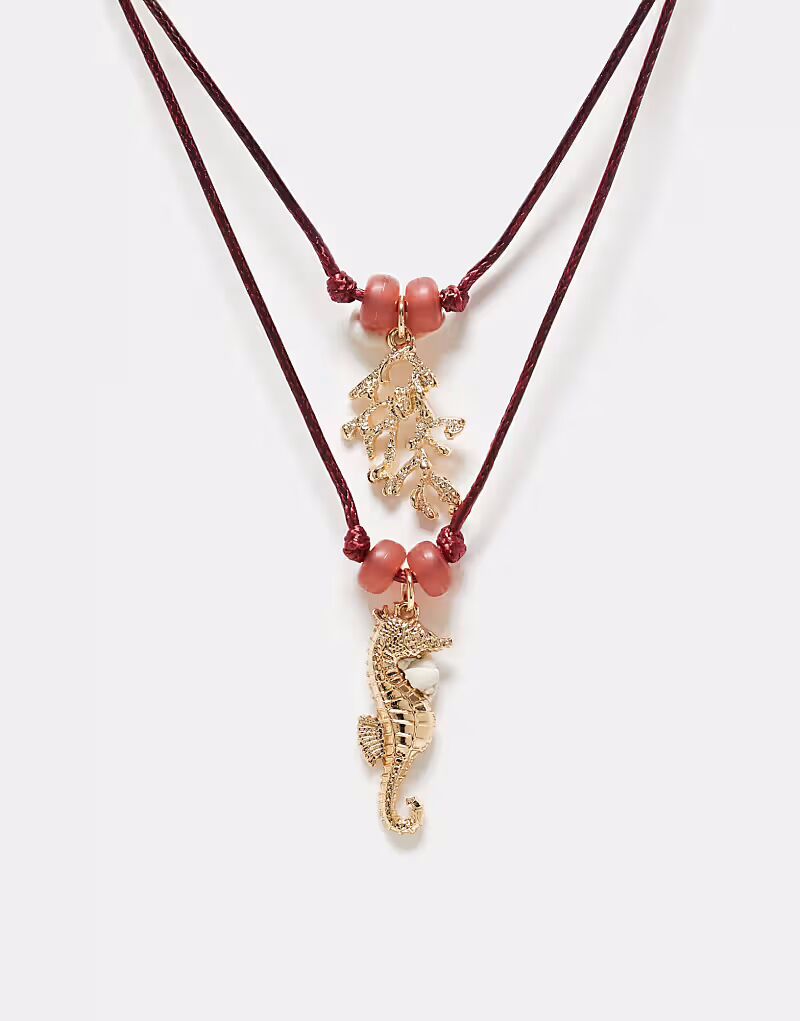 

Многорядное красное ожерелье с подвесками в виде морских обитателей золотистого оттенка Asos Design